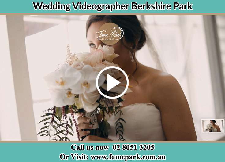 Bride smelling a bouquet of flowers near the window Berkshire Park NSW 2765