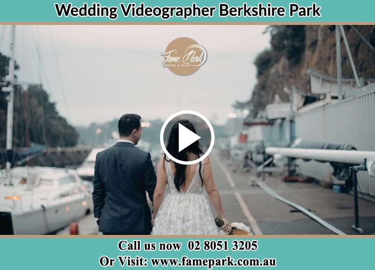 Bride and Groom hold hands while walking at the harbor Berkshire Park NSW 2765