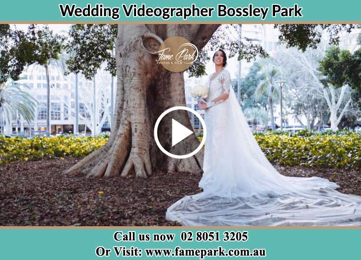 Bride holding a bouquet of flowers under the tree at the park Bossley Park NSW 2176