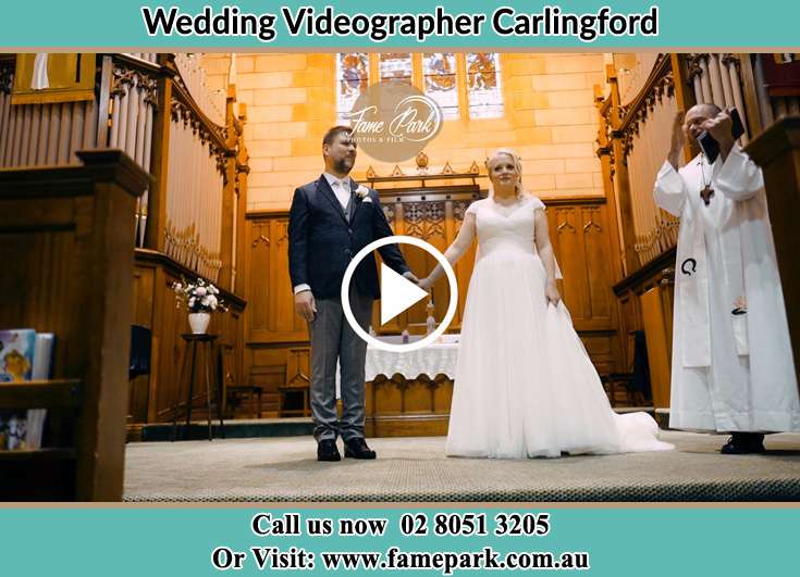 Bride and Groom at the altar with the priest Camellia NSW 2124