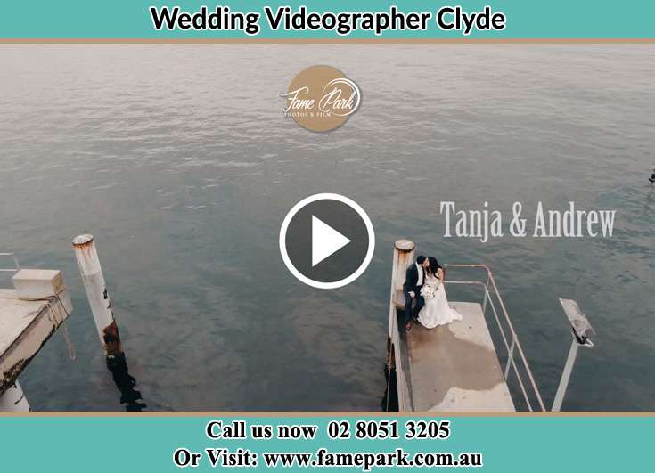 Bride and Groom kissed while sitting at the bay walk Clyde NSW 2142