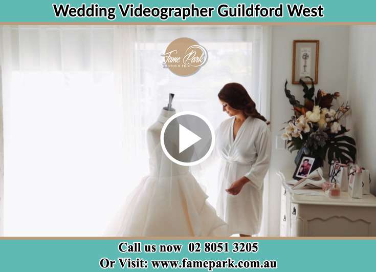 Bride looking at her wedding gown Guildford West NSW 2161