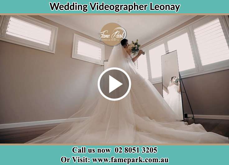 Bride looking at the mirror with bouquet of flowers Leonay NSW 2750