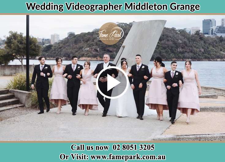 Bride and Groom with their secondary sponsors near the shore Middleton Grange NSW 2171