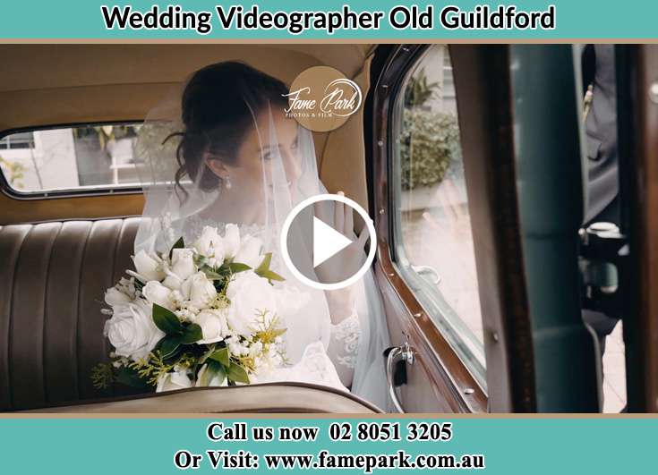 The Bride holding a bouquet of flowers inside the wedding car Old Guildford NSW 2161