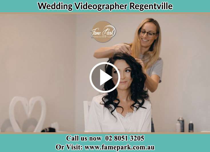 A girl fixing the Bride's hair Regentville NSW 2745