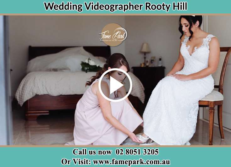 A bridesmaid putting a shoe onto the Bride's foot Rooty Hill NSW 2766