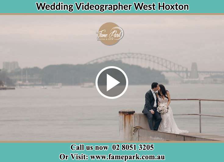 The newlyweds kissing near the shore West Hoxton NSW 2171